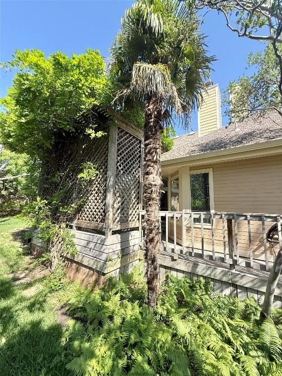 7011 Quill Leaf Cv, Austin, TX 78750 - view of side of home with a chimney and a shingled roof