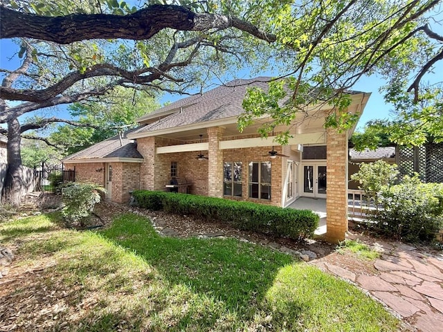 7011 Quill Leaf Cv, Austin, TX 78750 - rear view of property with ceiling fan, brick siding, and a shingled roof