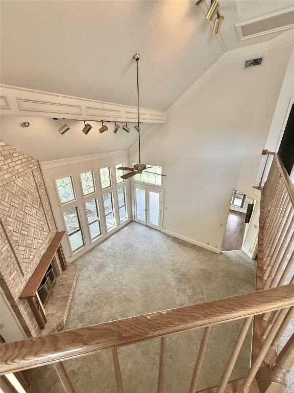 7011 Quill Leaf Cv, Austin, TX 78750 - stairway with a ceiling fan, carpet floors, and high vaulted ceiling