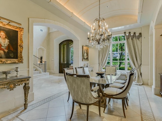 tiled dining area with a raised ceiling