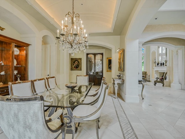 4406 Silent Trl, Austin, TX 78746 - dining area featuring arched walkways, a chandelier, and light tile patterned floors