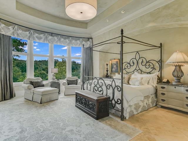 4406 Silent Trl, Austin, TX 78746 - tiled bedroom featuring multiple windows, a high ceiling, and a tray ceiling