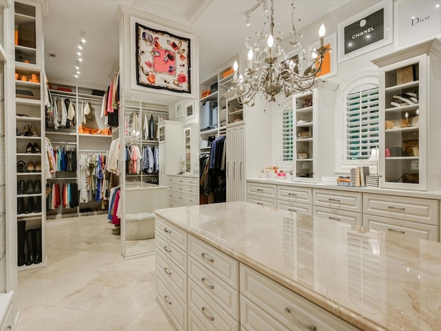 walk in closet featuring a chandelier