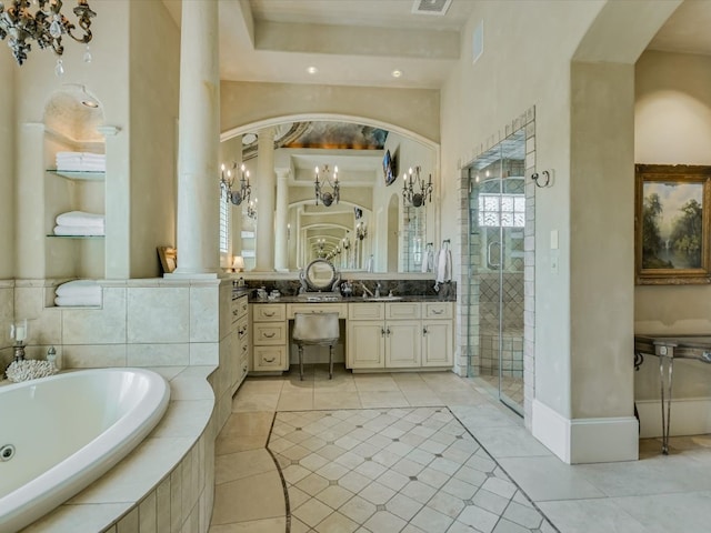 bathroom with decorative columns, vanity, separate shower and tub, and tile patterned flooring