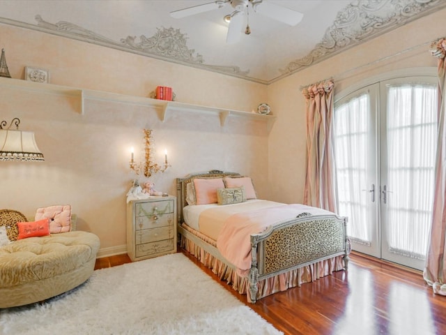 bedroom with wood-type flooring, ceiling fan, access to exterior, and french doors