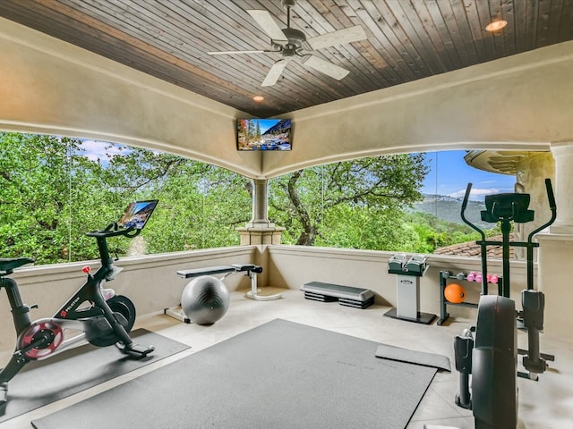 workout area with ceiling fan and wood ceiling