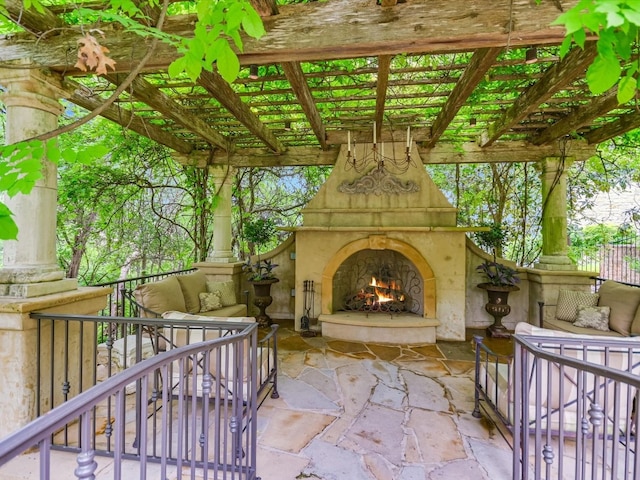 view of patio with an outdoor living space with a fireplace and a pergola