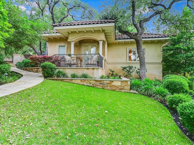 4406 Silent Trl, Austin, TX 78746 - view of front of home with a tiled roof, a front yard, and stucco siding
