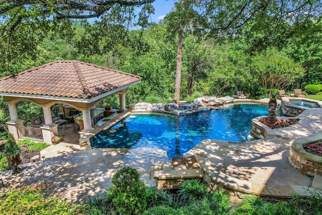 view of pool with an in ground hot tub, a patio area, and a gazebo