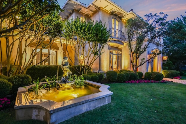 4406 Silent Trl, Austin, TX 78746 - view of front of house with a balcony, a front yard, and stucco siding