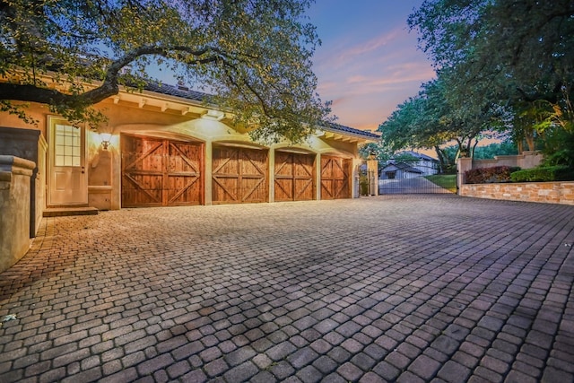 view of garage at dusk