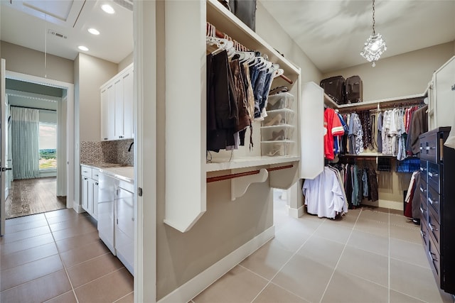 spacious closet featuring light tile patterned floors