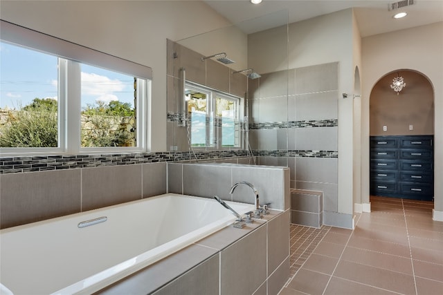 bathroom with plus walk in shower and tile patterned flooring