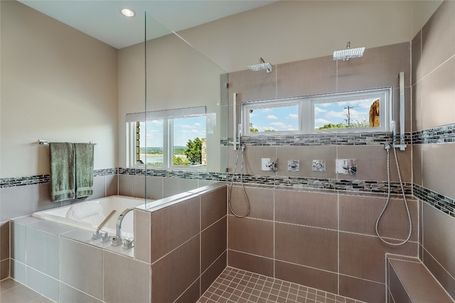 bathroom featuring plus walk in shower and tile patterned flooring