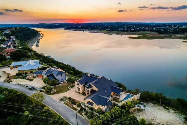 aerial view at dusk with a water view