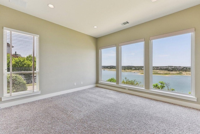 1612 Watercliffe Dr, Lago Vista, TX 78645 - carpeted spare room featuring a water view, baseboards, and recessed lighting