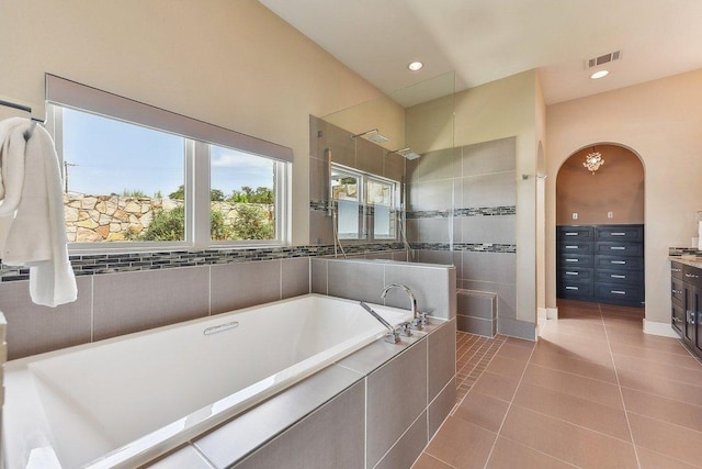1612 Watercliffe Dr, Lago Vista, TX 78645 - bathroom with tile patterned flooring, a garden tub, vanity, a walk in shower, and recessed lighting