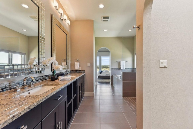 1612 Watercliffe Dr, Lago Vista, TX 78645 - ensuite bathroom with plenty of natural light, double vanity, tile patterned floors, recessed lighting, and a textured wall