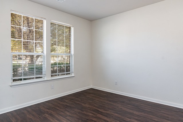 unfurnished room with dark hardwood / wood-style floors