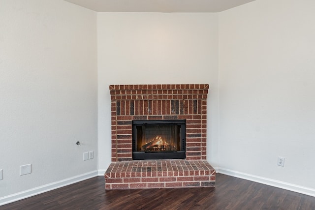 room details with a brick fireplace and hardwood / wood-style flooring