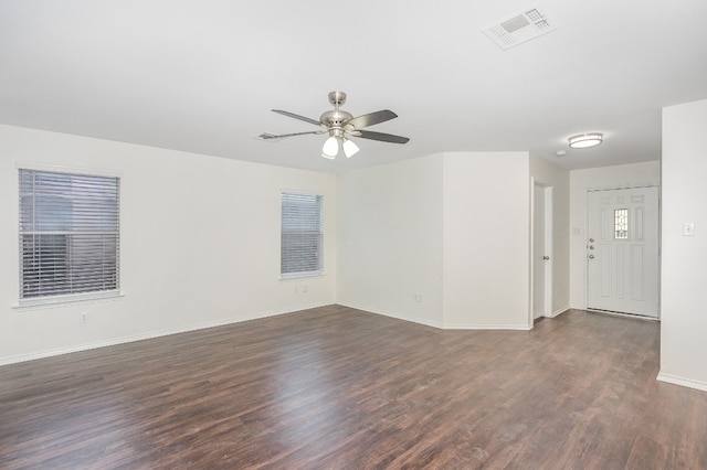 empty room with ceiling fan and dark wood-type flooring