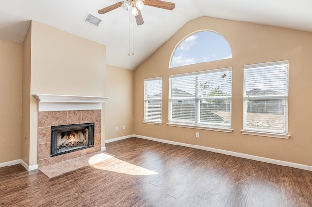 unfurnished living room featuring ceiling fan, lofted ceiling, dark hardwood / wood-style floors, and a fireplace