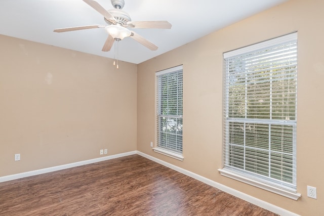 empty room with hardwood / wood-style floors, a wealth of natural light, and ceiling fan