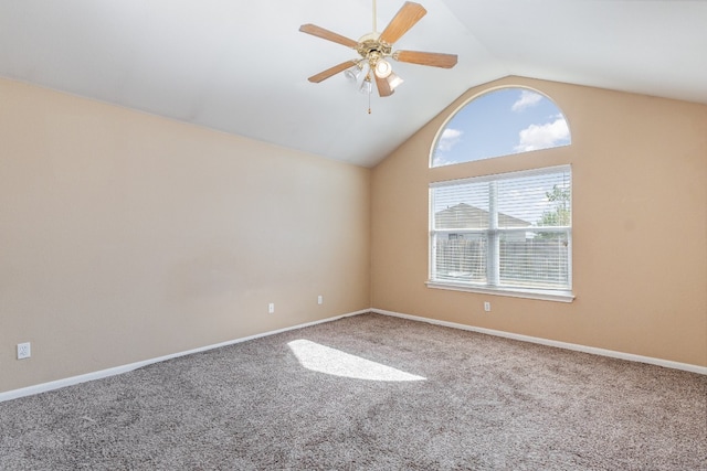 spare room featuring carpet flooring, lofted ceiling, and ceiling fan