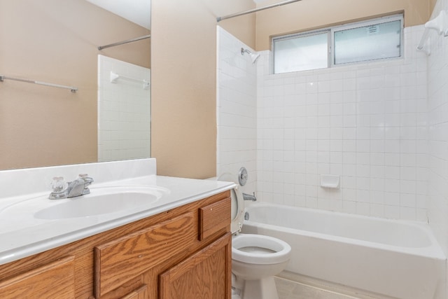 full bathroom featuring toilet, vanity, and tiled shower / bath