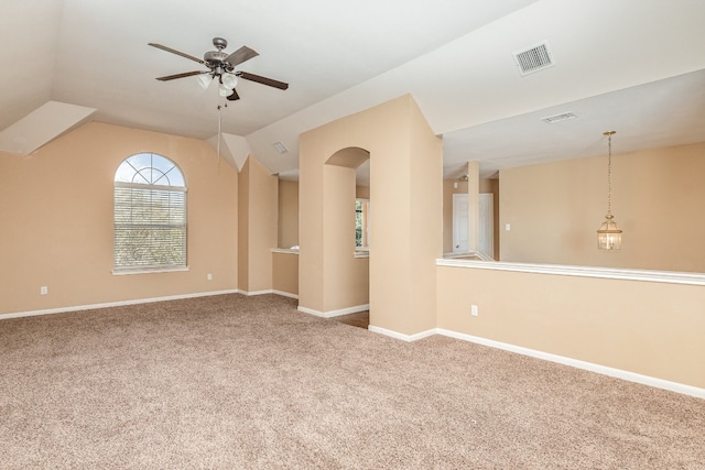 carpeted spare room featuring lofted ceiling and ceiling fan