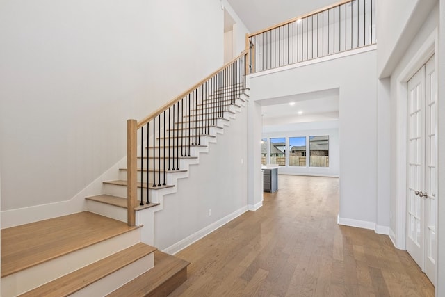 entryway featuring a high ceiling and hardwood / wood-style floors