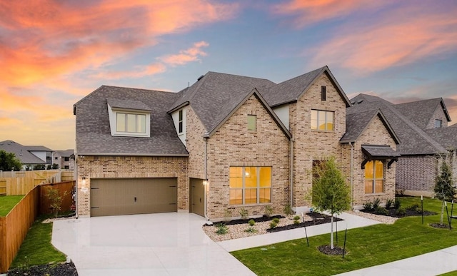 view of front of property featuring a lawn and a garage