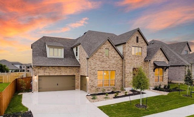 105 Bull Ridge Trl, Georgetown, TX 78628 - french provincial home featuring an attached garage, brick siding, driveway, and a shingled roof