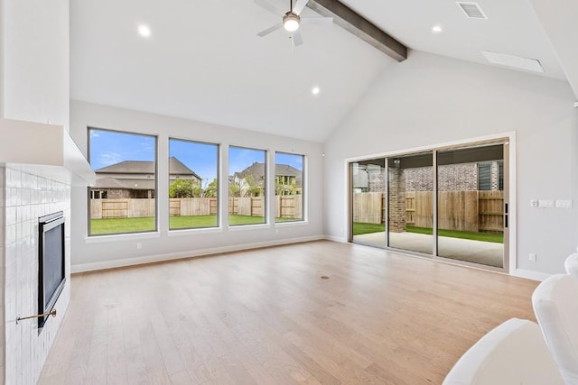 105 Bull Ridge Trl, Georgetown, TX 78628 - unfurnished living room with beamed ceiling, a tiled fireplace, wood finished floors, high vaulted ceiling, and a ceiling fan