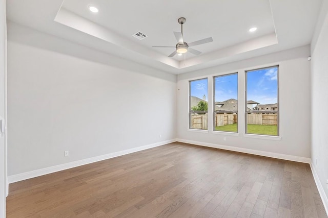 105 Bull Ridge Trl, Georgetown, TX 78628 - spare room featuring a raised ceiling, wood finished floors, baseboards, a ceiling fan, and recessed lighting