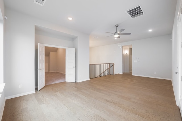 empty room with light wood-type flooring and ceiling fan