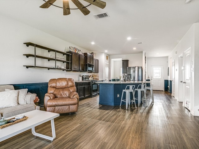 living room with ceiling fan, sink, and dark hardwood / wood-style flooring