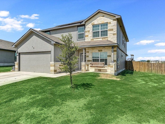 traditional home with fence, concrete driveway, stone siding, a front yard, and a garage