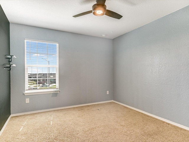 unfurnished room featuring baseboards, carpet flooring, and ceiling fan