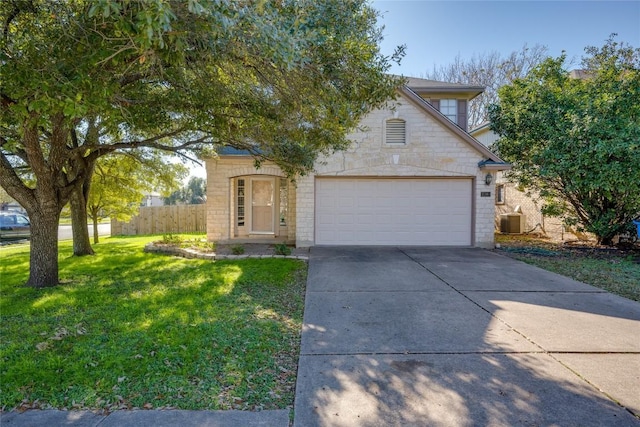 view of front of home with a front yard, central AC unit, and a garage