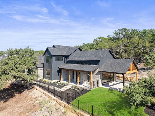 rear view of property with a lawn and a patio