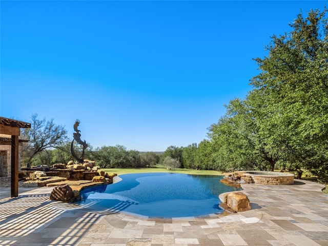 view of swimming pool with a patio, a water view, and an in ground hot tub