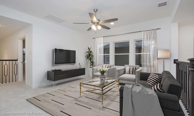 carpeted living room with ceiling fan