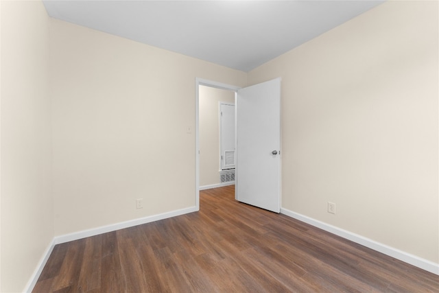 empty room featuring dark hardwood / wood-style flooring