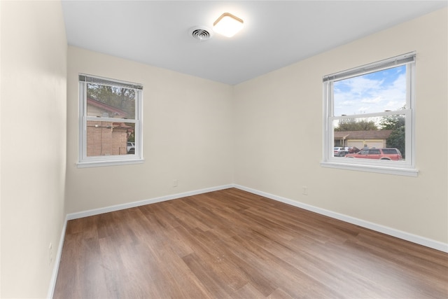 spare room featuring hardwood / wood-style floors