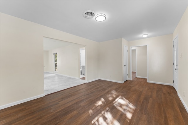 empty room featuring dark hardwood / wood-style flooring