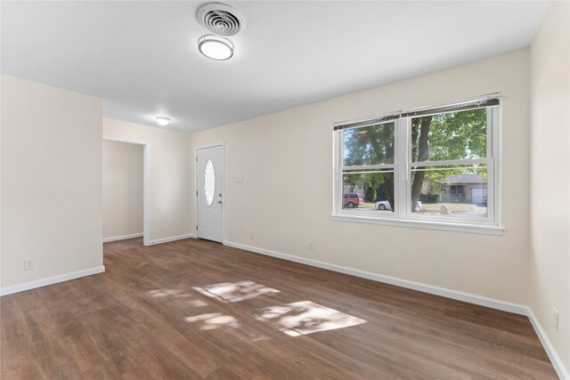 spare room featuring dark hardwood / wood-style flooring