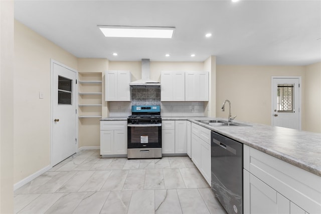 kitchen with wall chimney range hood, white cabinetry, stainless steel appliances, and sink