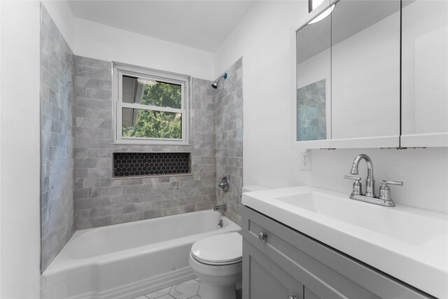 full bathroom with vanity, toilet, tiled shower / bath combo, and tile patterned flooring