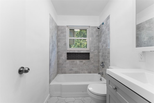 full bathroom featuring vanity, toilet, tiled shower / bath combo, and tile patterned flooring